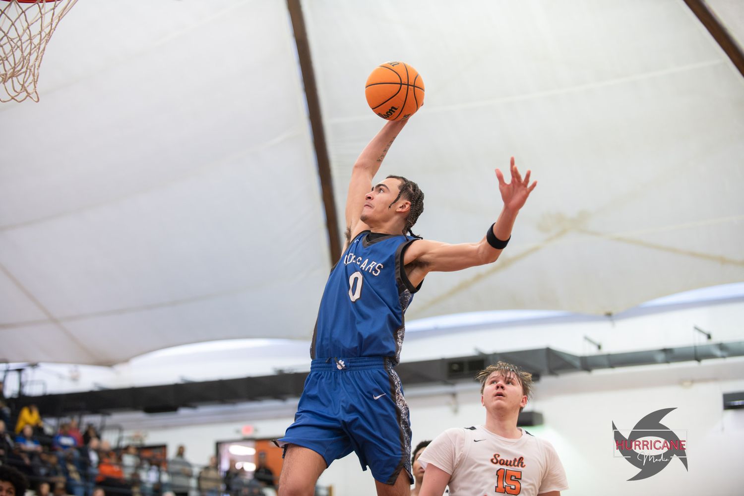 Basketball players compete for the ball during an intense indoor game showing multiple action shots.
