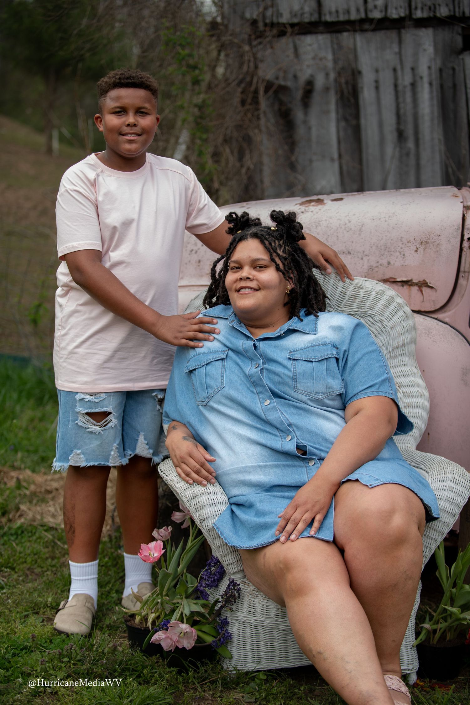 Two people relaxing on outdoor vintage furniture during casual photo session.