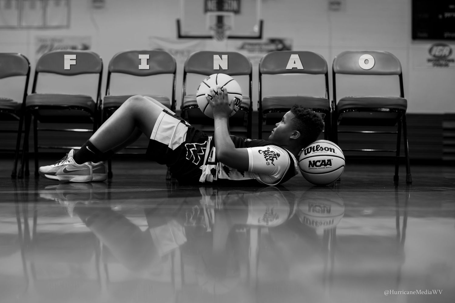 Empty gymnasium bleachers shown in black and white photography.
