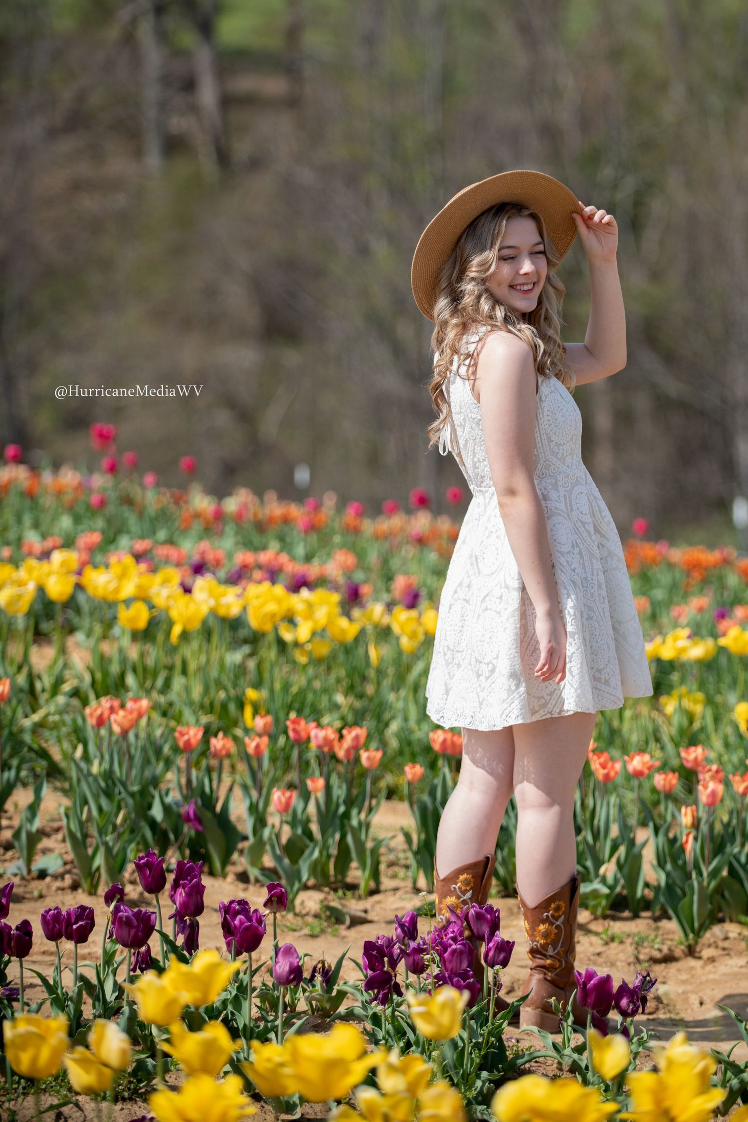 Beautiful tulip garden featuring yellow, orange and purple flowers with boots visible.