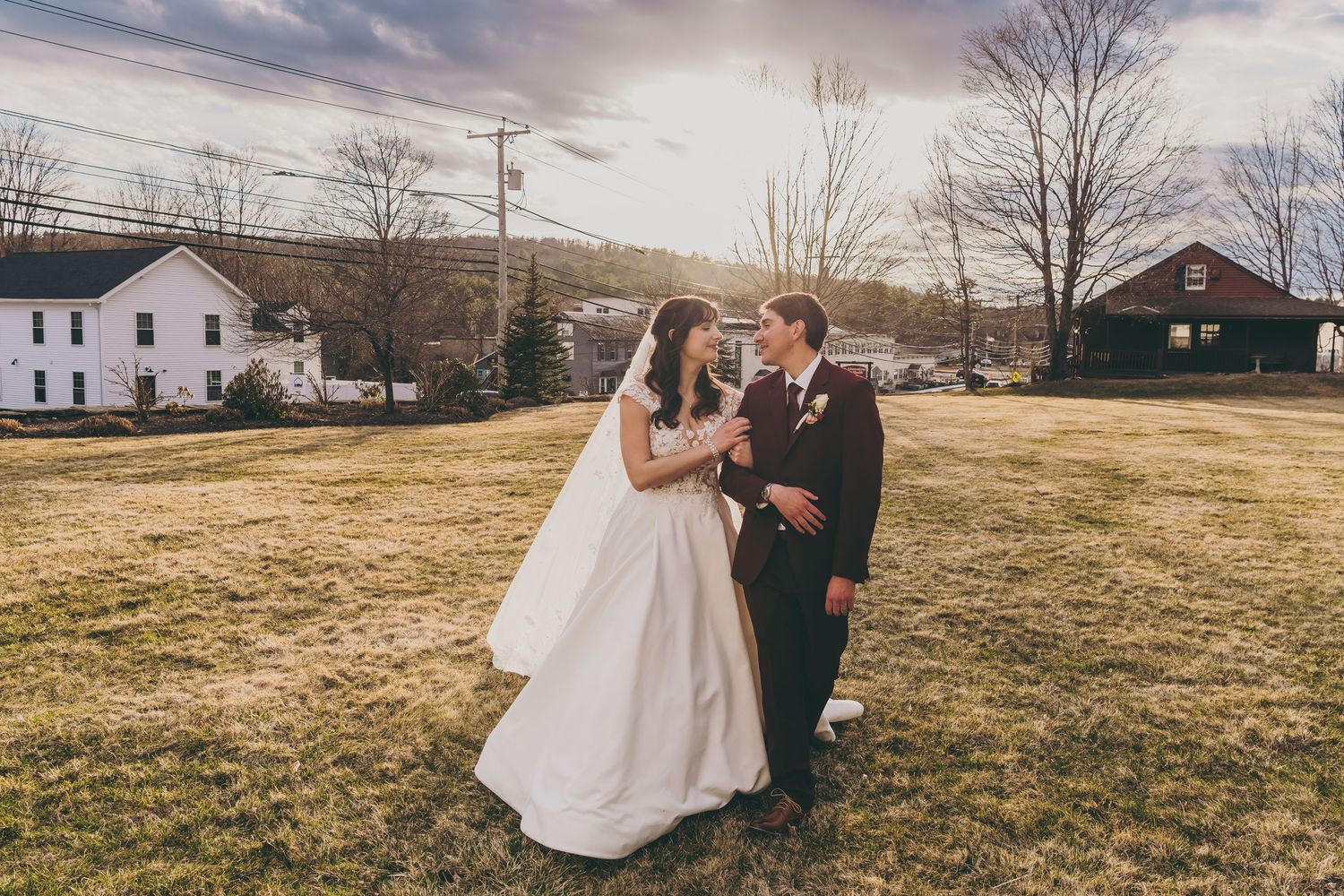 Wedding ceremony setup in a scenic countryside location with bare winter trees in background.