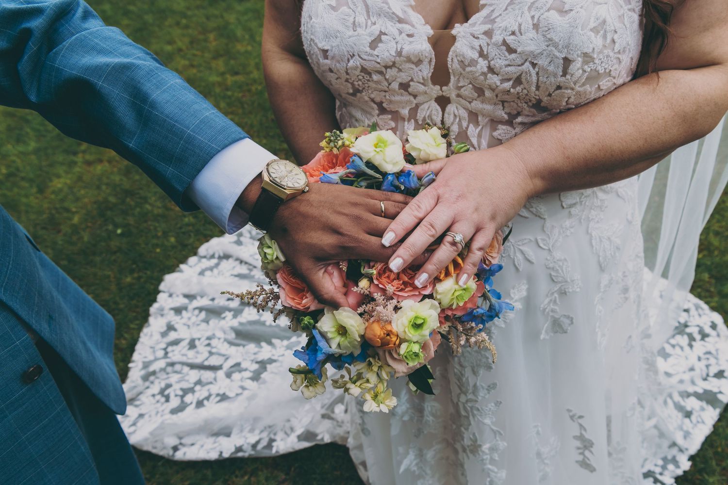 Close-up detail shots of hands holding a flower bouquet at an outdoor wedding ceremony with lace dress details.