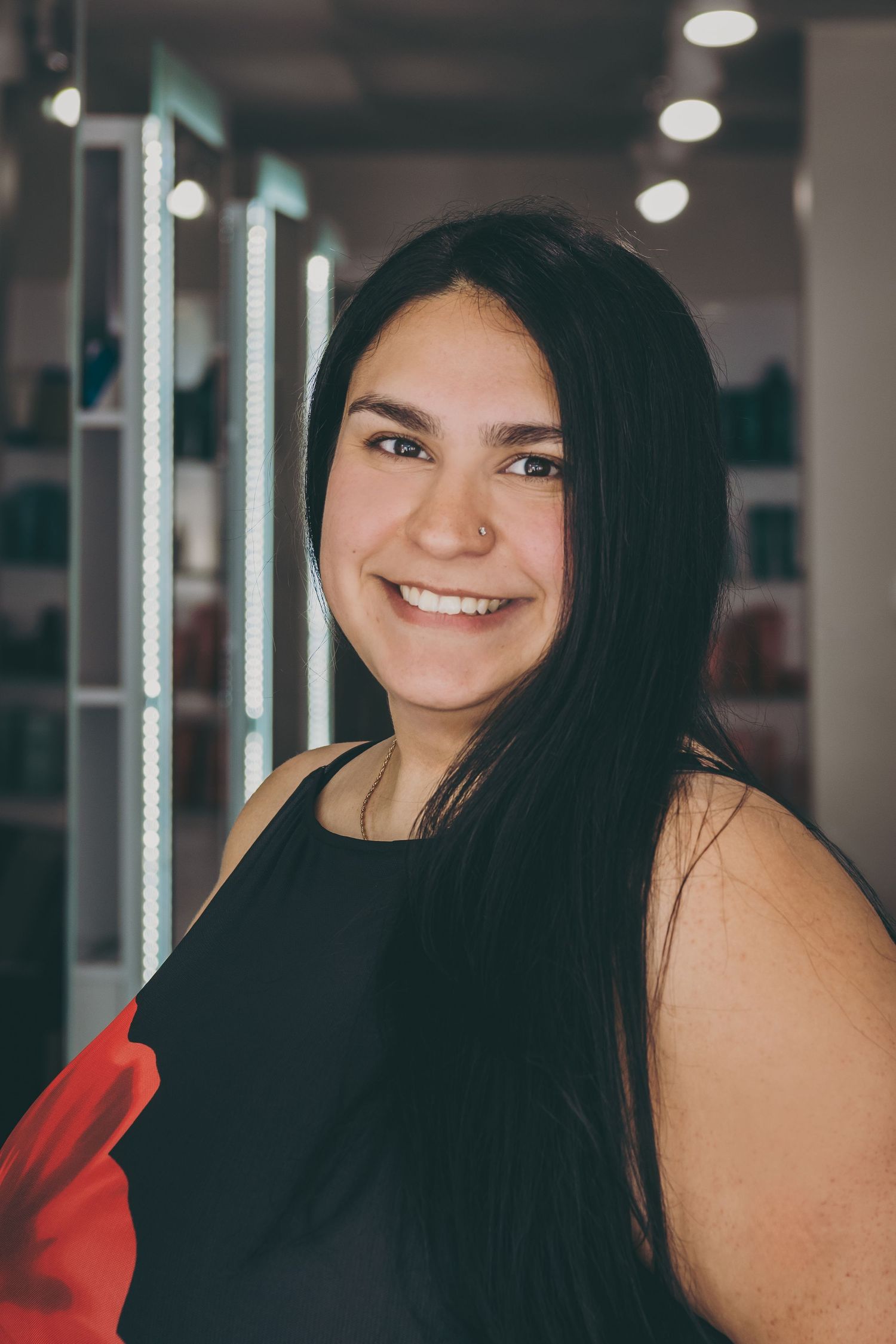 Professional headshots showing bright smiles in modern studio setting.