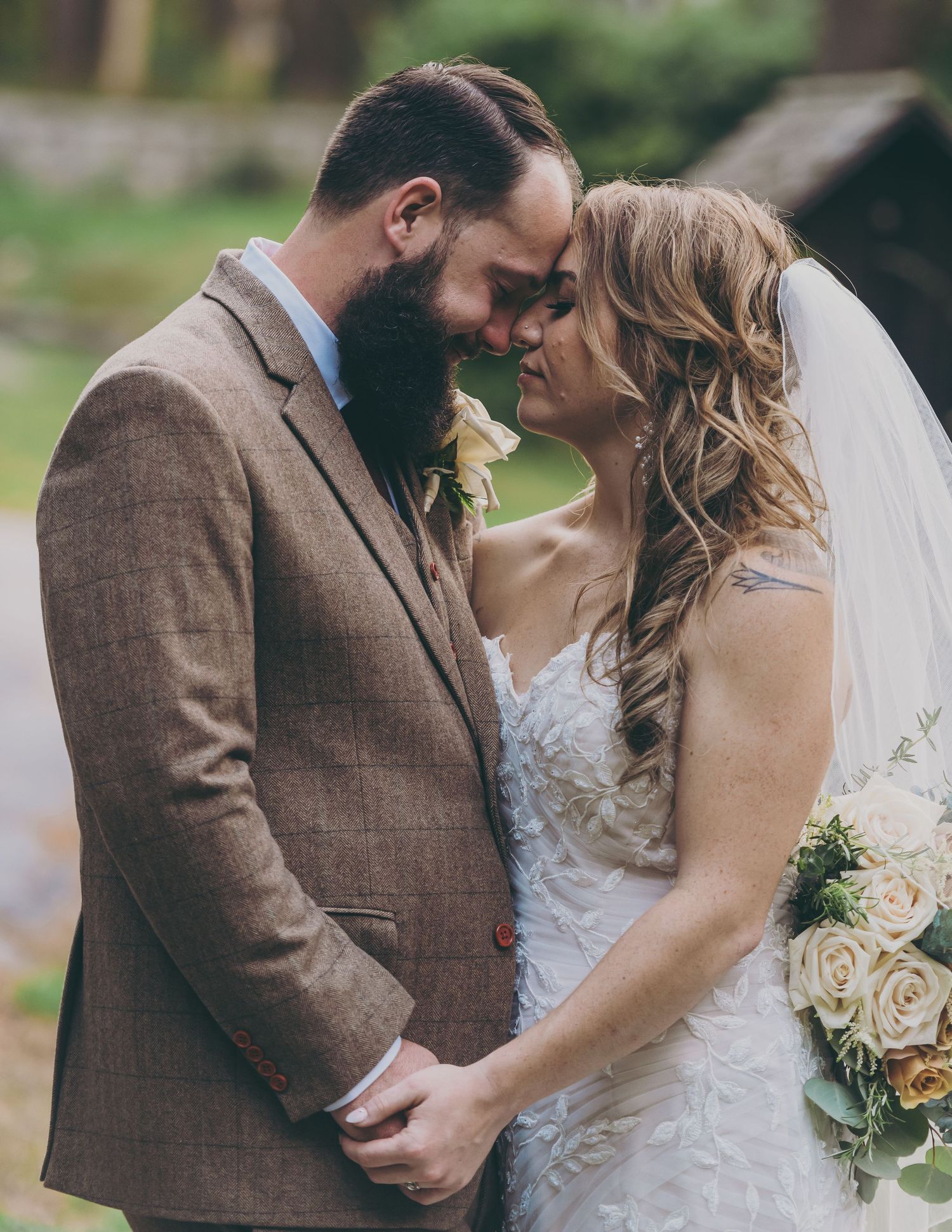 A romantic outdoor wedding photoshoot with soft natural lighting and rustic brown tones.