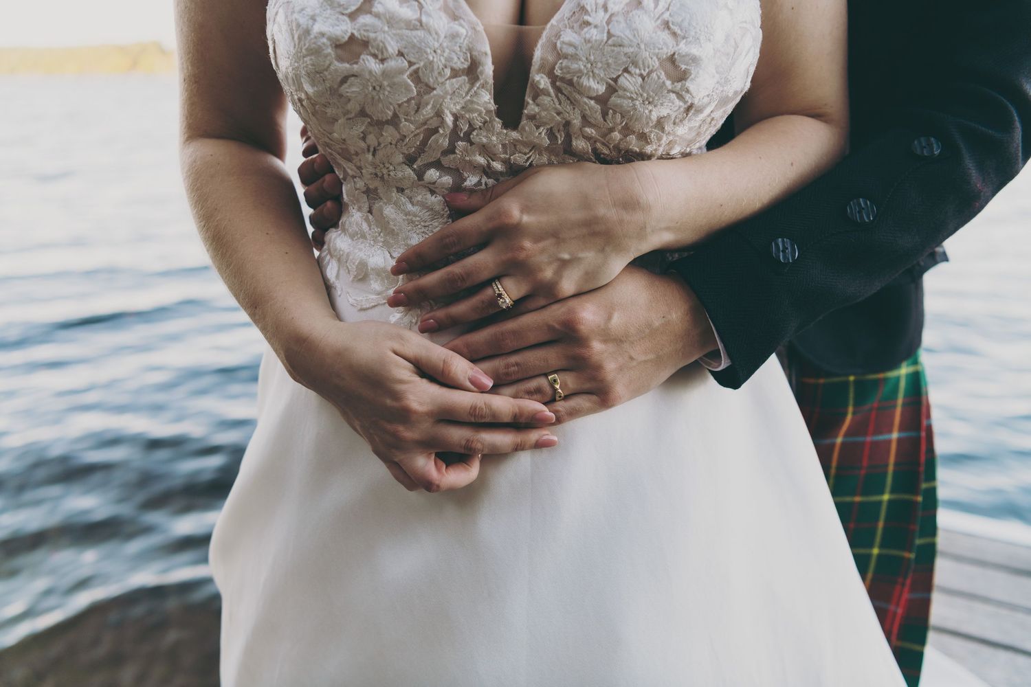 Close-up detail shots of a white lace wedding dress with delicate embroidery patterns.