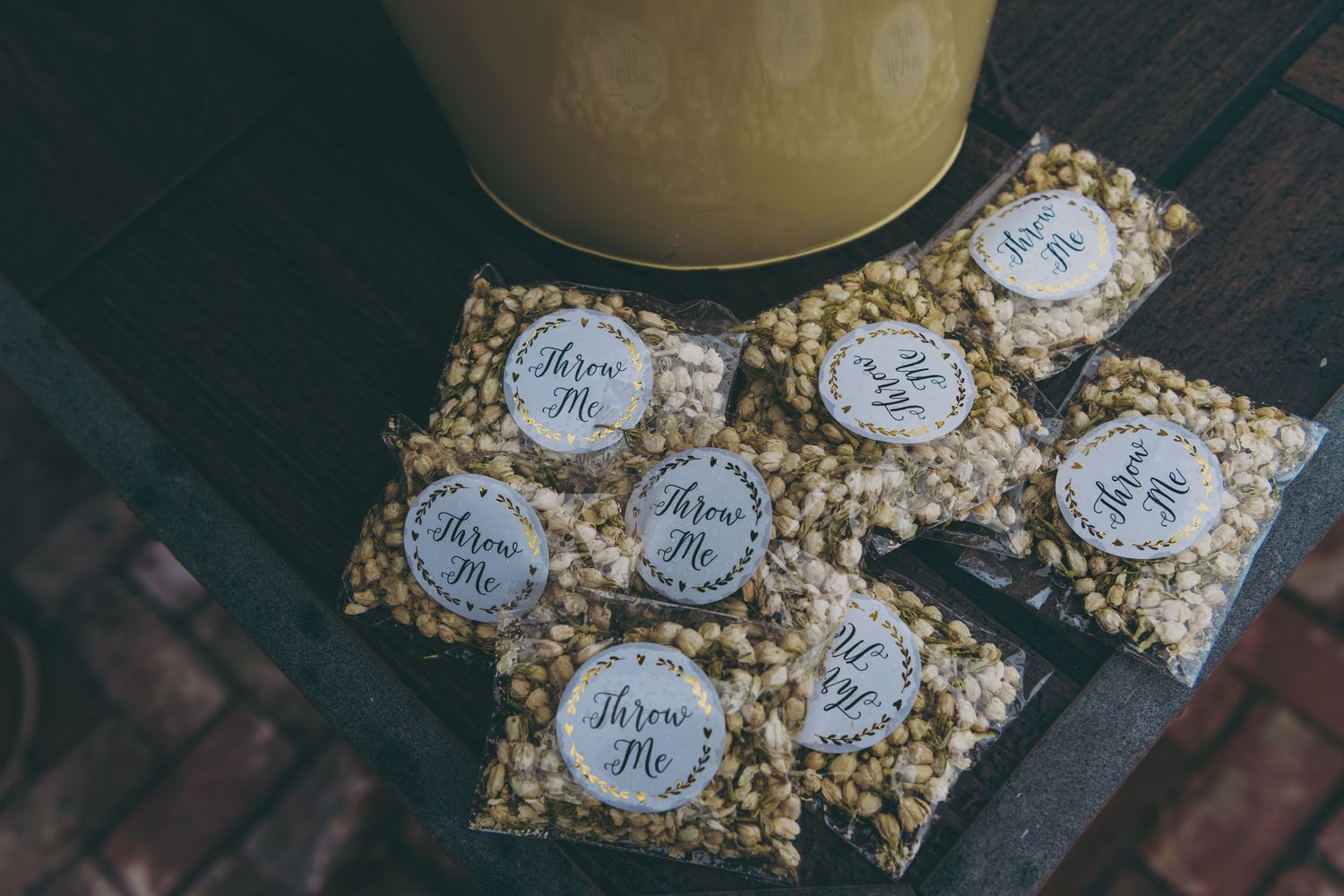 Small bags of popcorn with custom labeled stickers arranged on a dark surface.