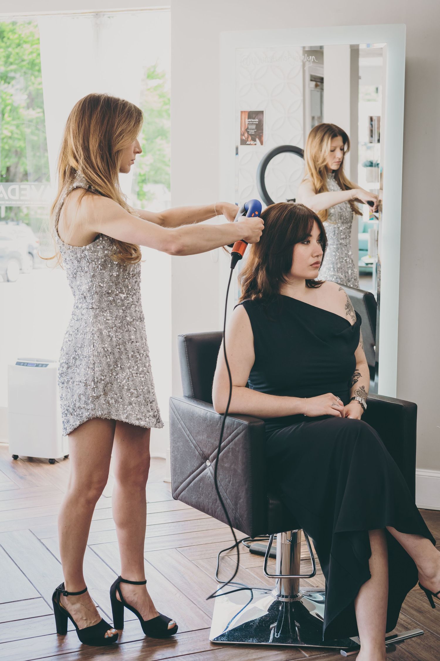 Candid behind-the-scenes photoshoot moments in a bright interior space.