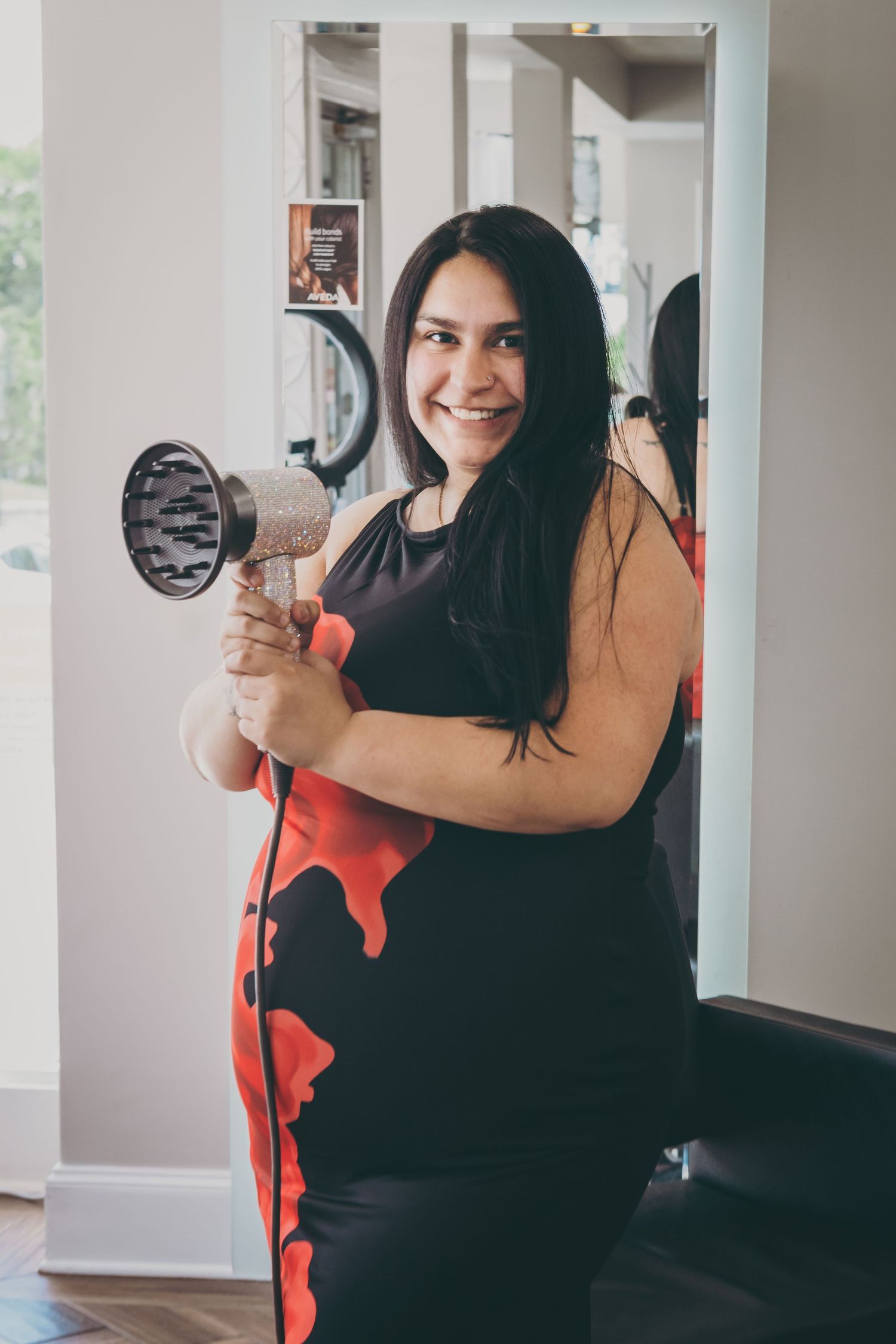 Casual portrait session with person in black outfit against white walls.