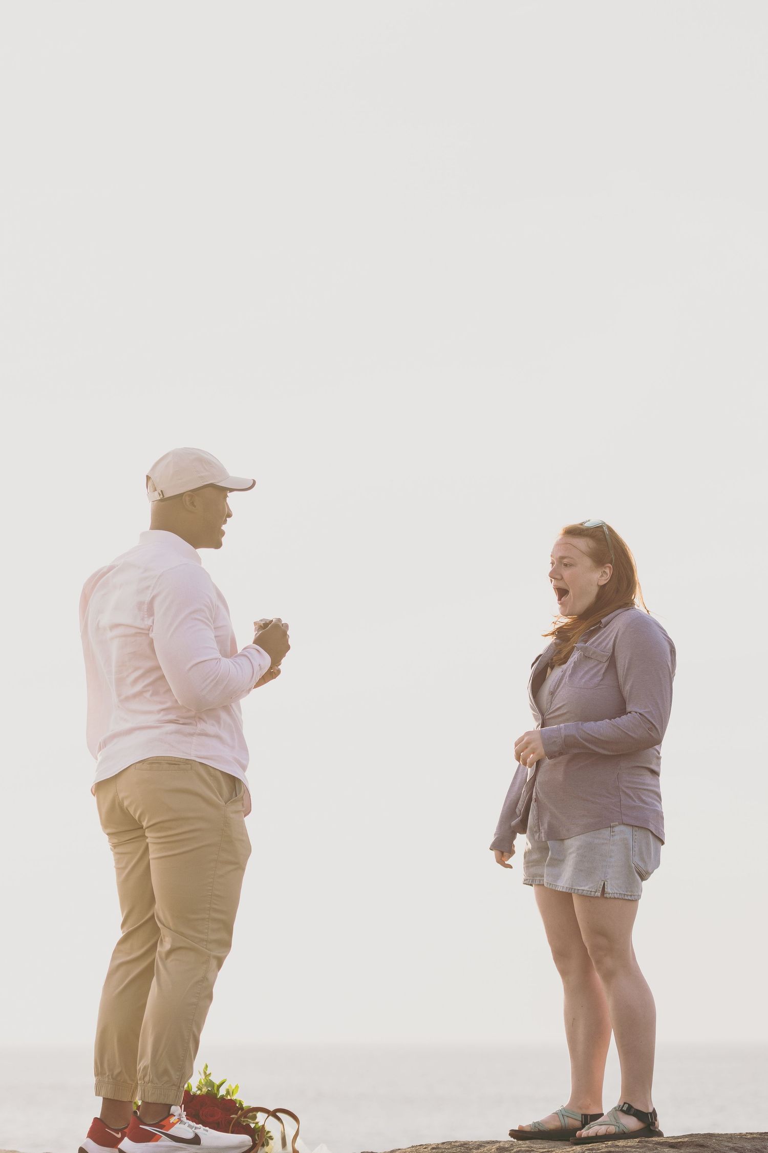 Sequence of romantic photos showing a couple in casual beige and pink outfits posing together by a coastline.