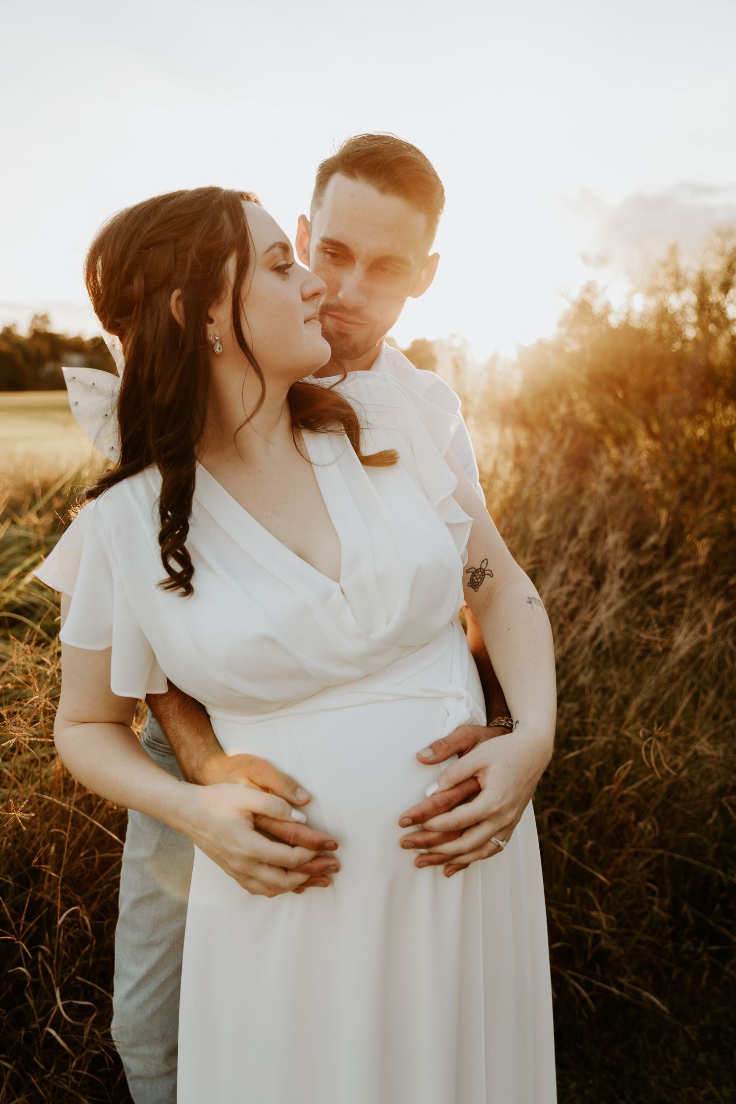 A couple embracing with the warm setting sun surrounding them