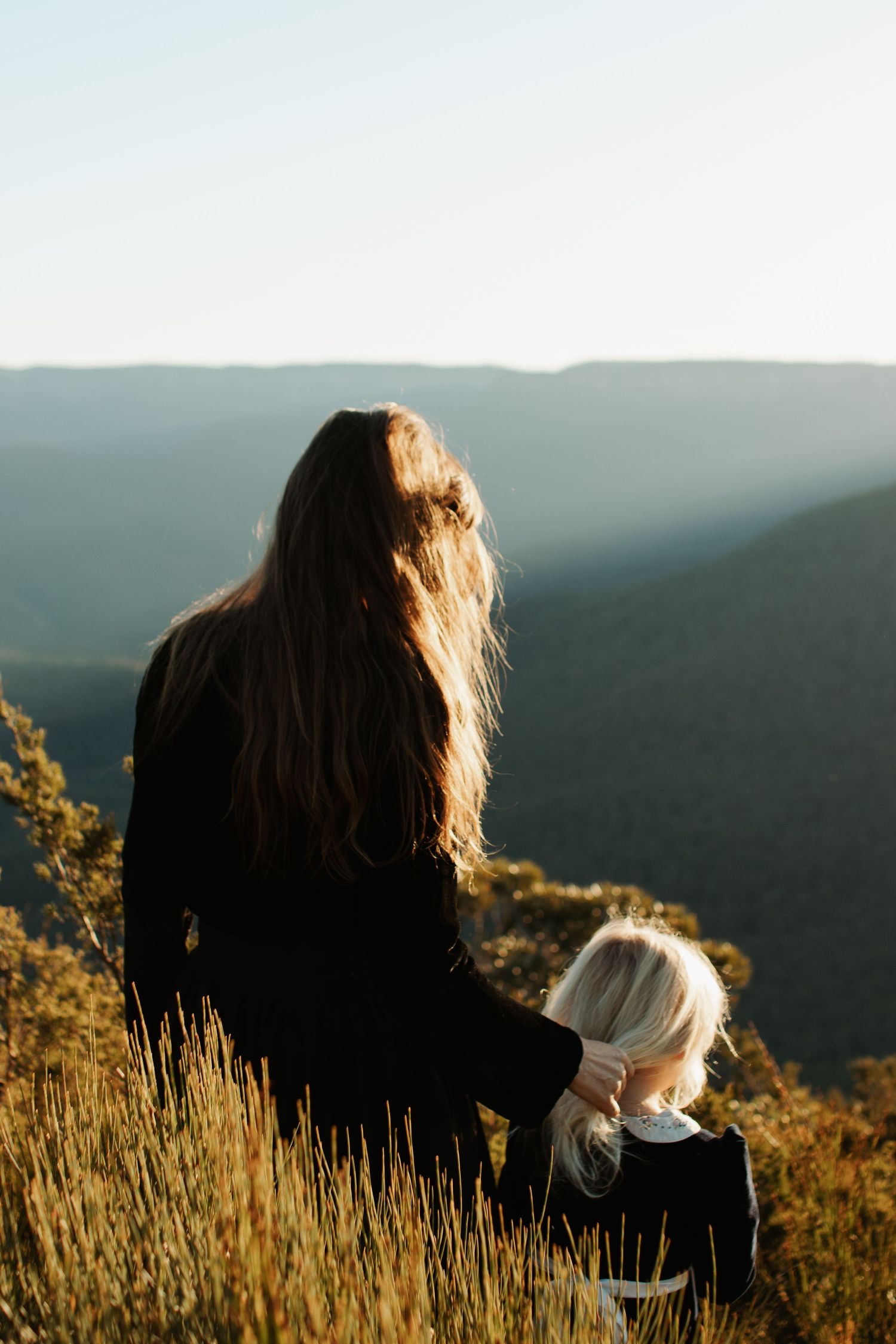 A mother and daughter looking out at the escarpment of the Blue Mountains