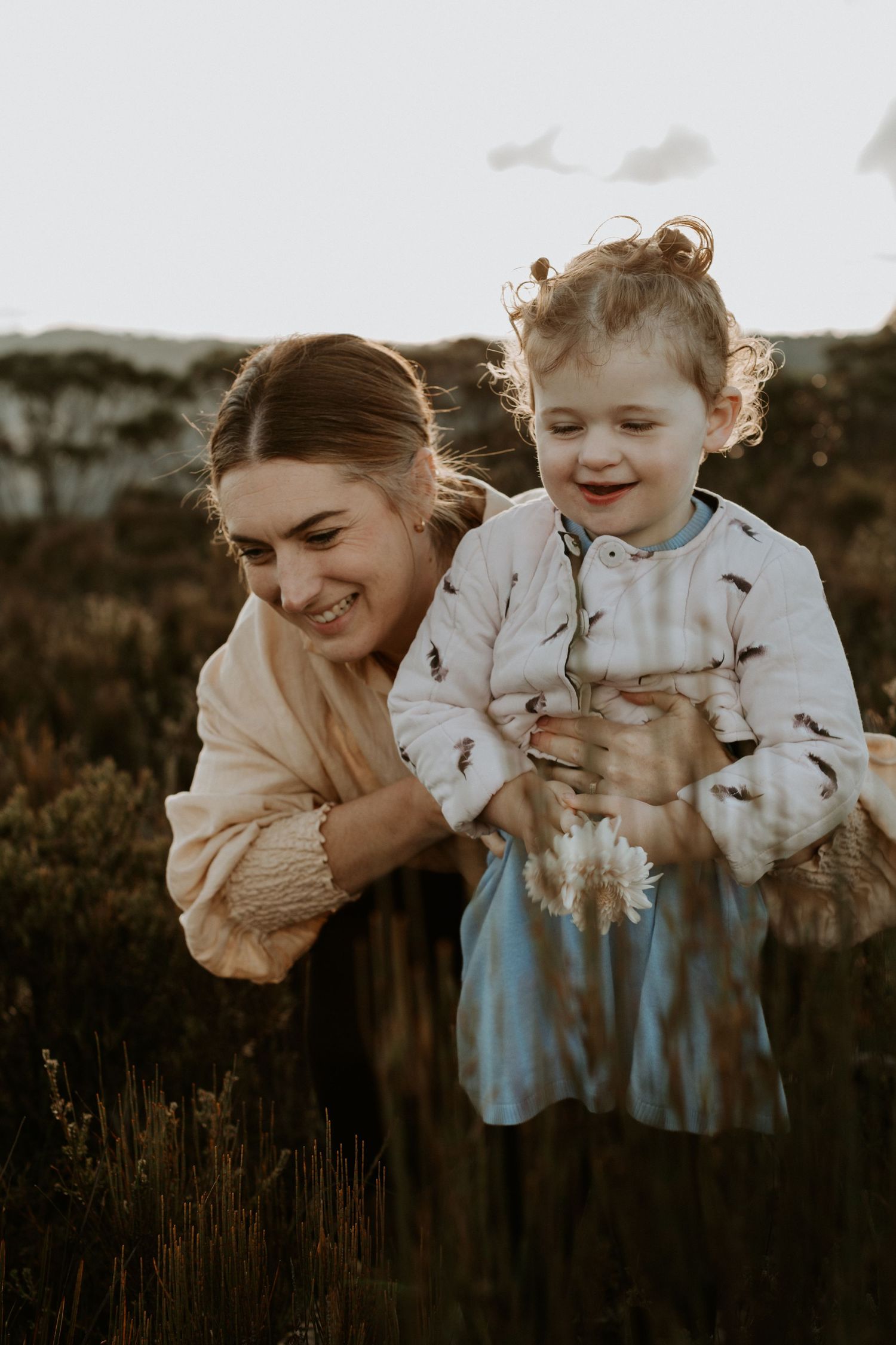 A mother and her daughter smiling together