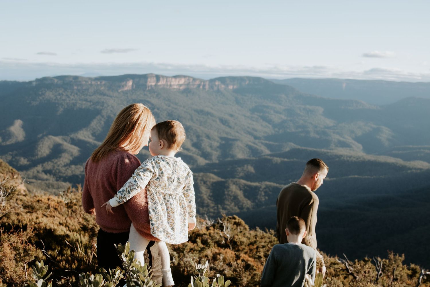 A family walking with the beautiful Blue Mountains backdrop in the back ground