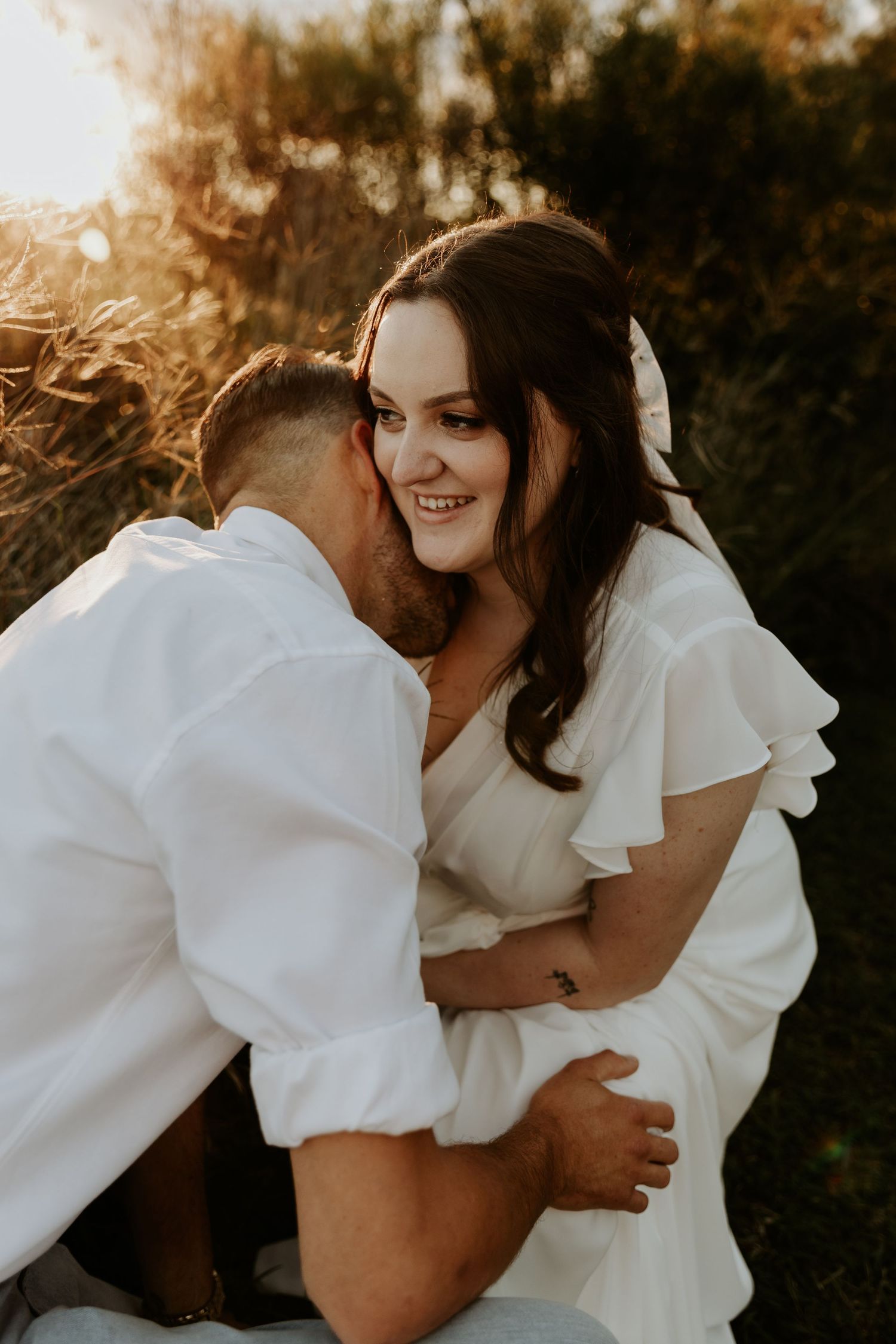 A couple embracing with the warm setting sun surrounding them
