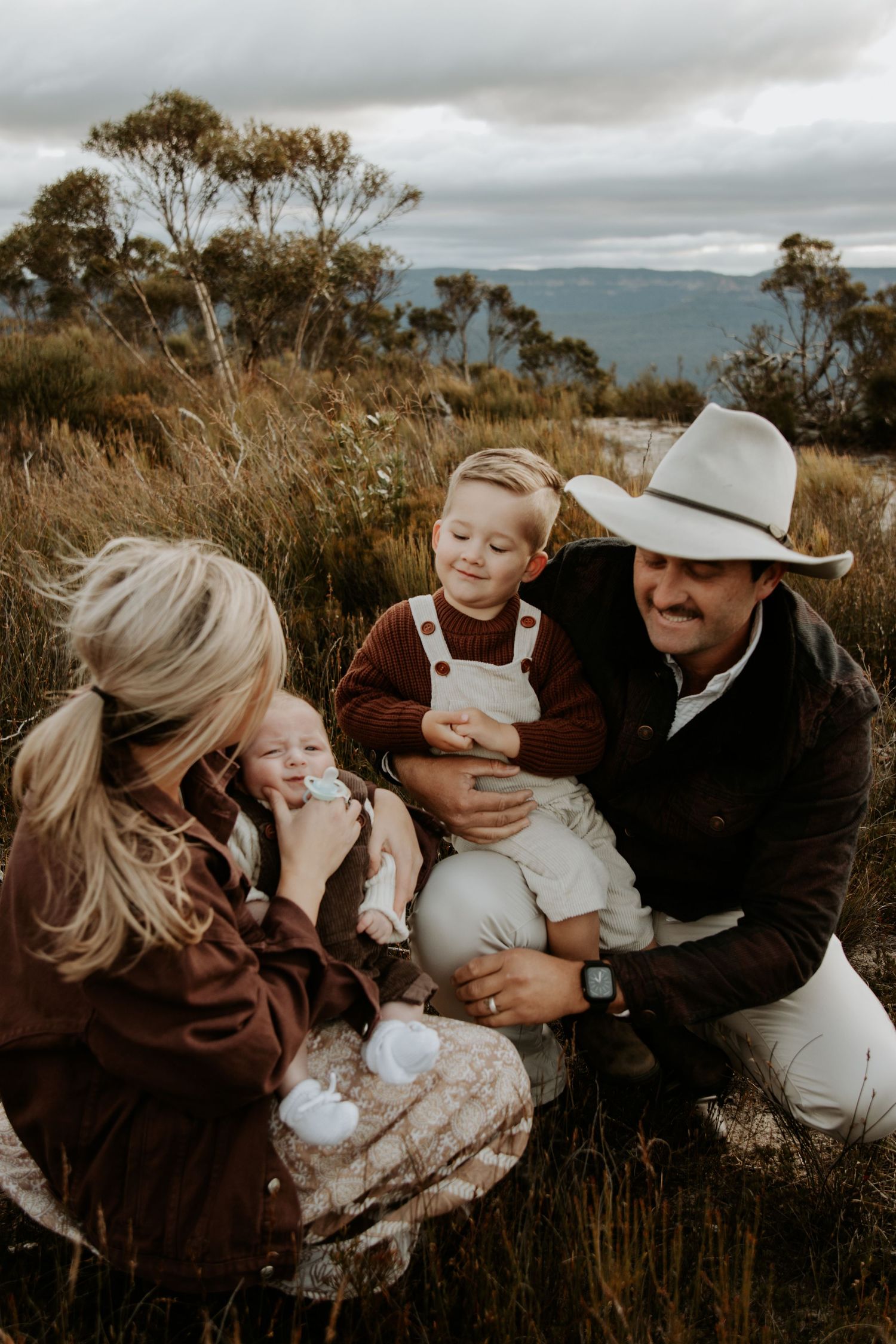 A family of four in nature with a baby and toddler in the Blue Mountains