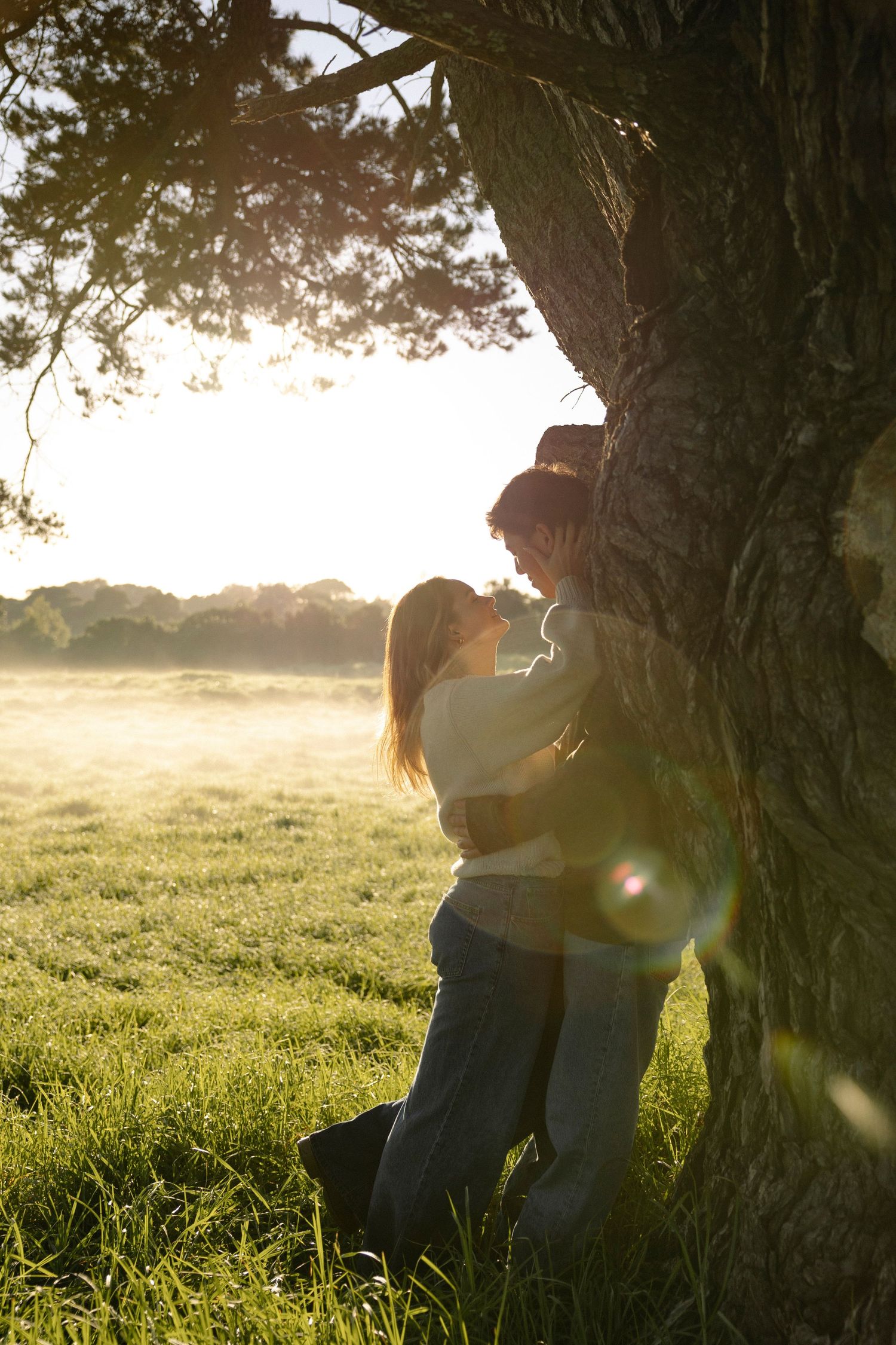 Couple embracing under tree