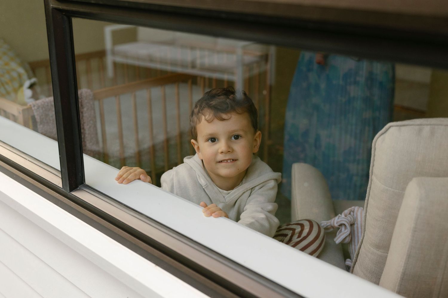 Little boy photographed through a window