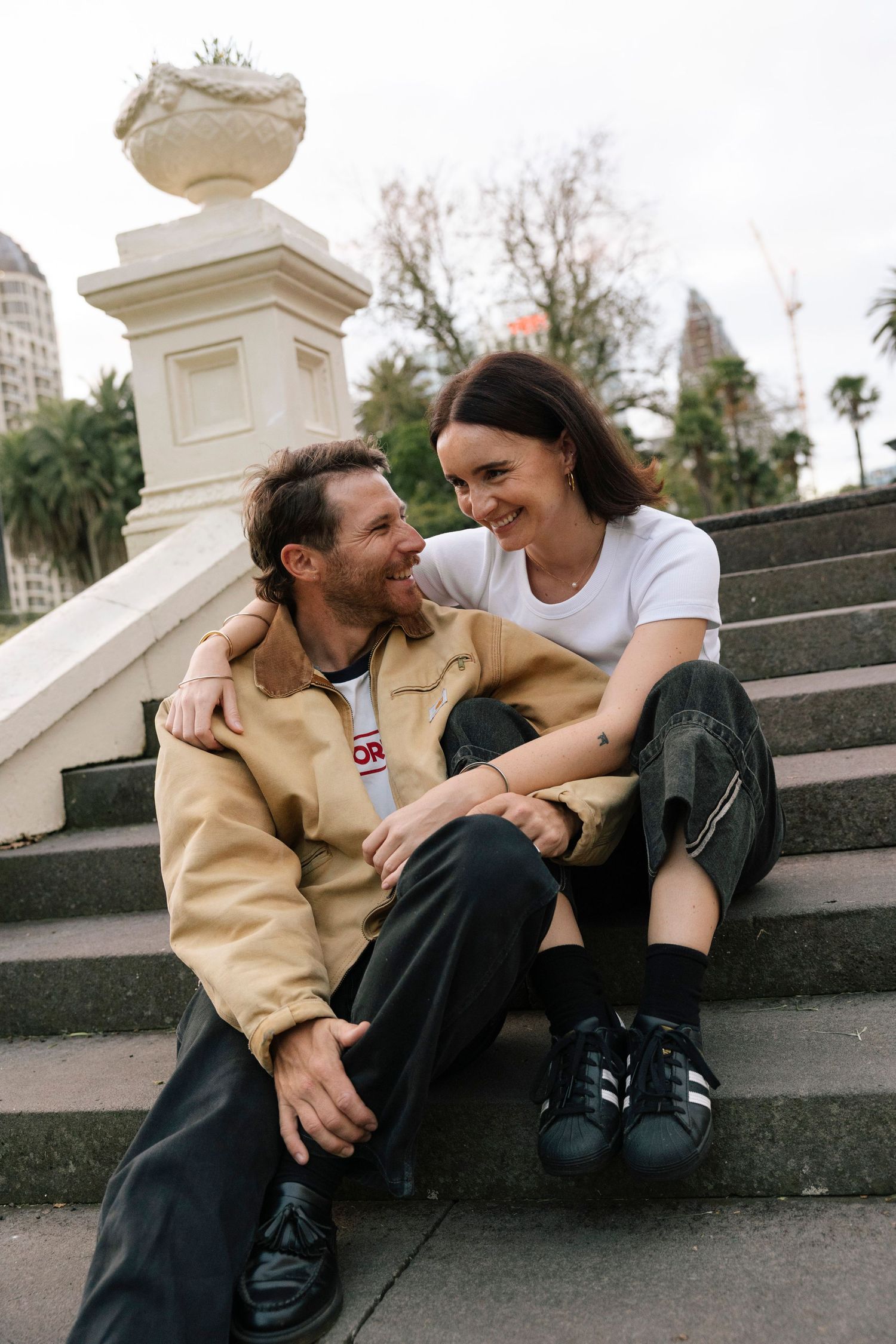 Couple laughing on steps in Albert Park