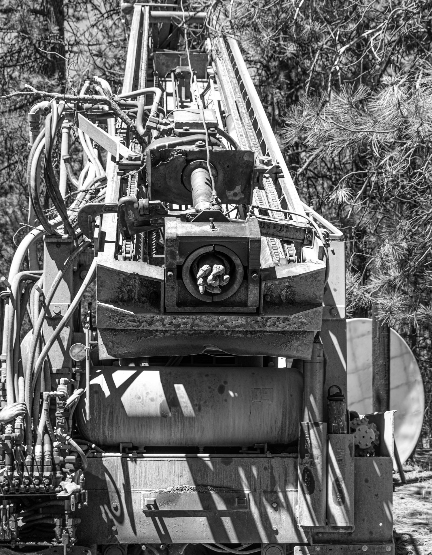 Vintage industrial machinery with complex mechanical components and gears in black and white.