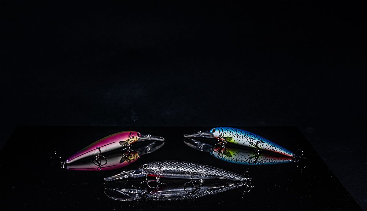 Colorful fishing lures and tackle displayed on dark background showing various styles and designs for sport fishing.