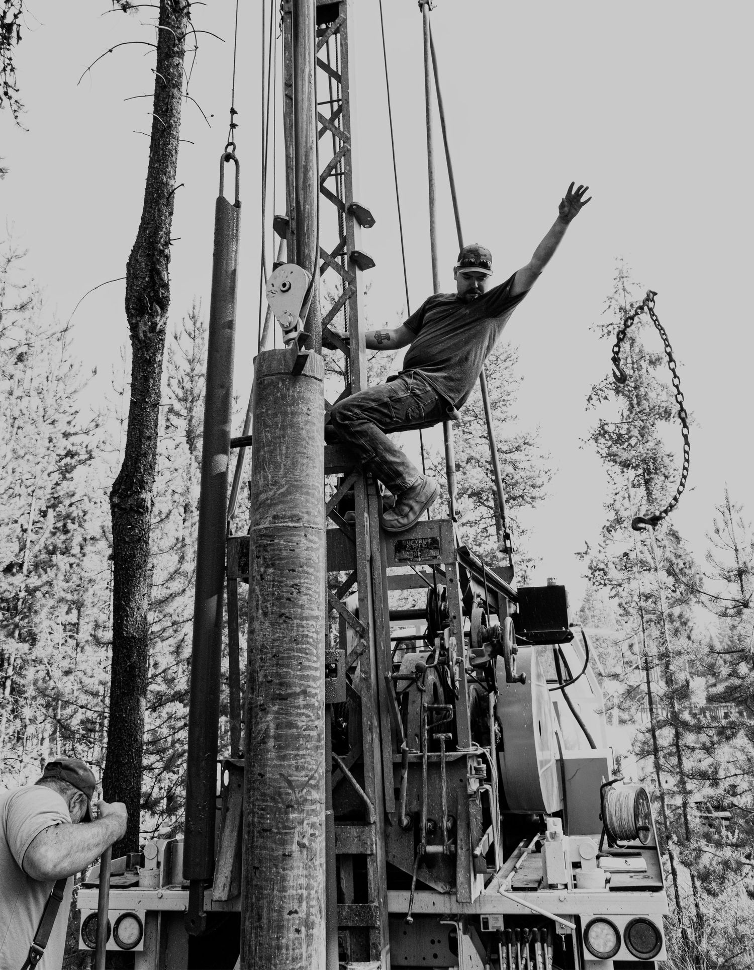 Industrial drilling equipment operation in a wooded setting.
