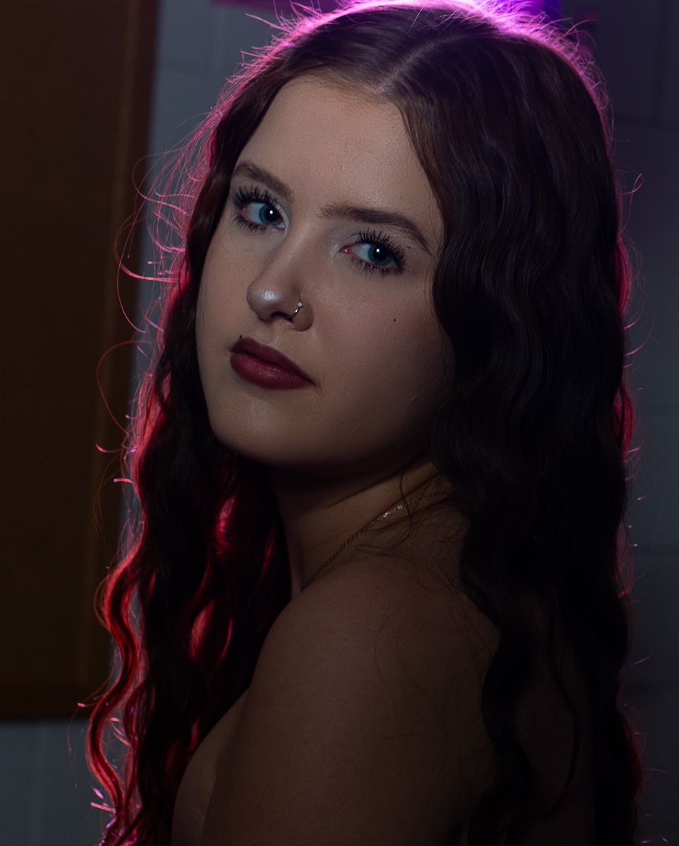 A dramatic portrait series with moody lighting featuring dark hair and red and purple illumination effects.
