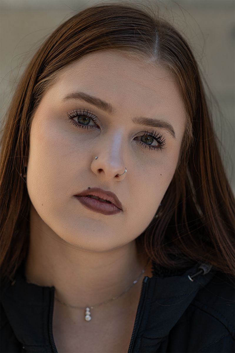 A series of close-up portrait shots showing dramatic lighting and dark lipstick against a dark background.