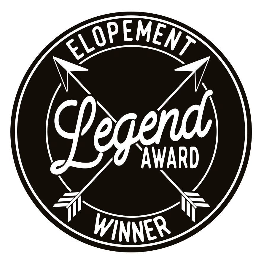 Black and white circular logo design for Elopement Legend Award with crossed arrows.