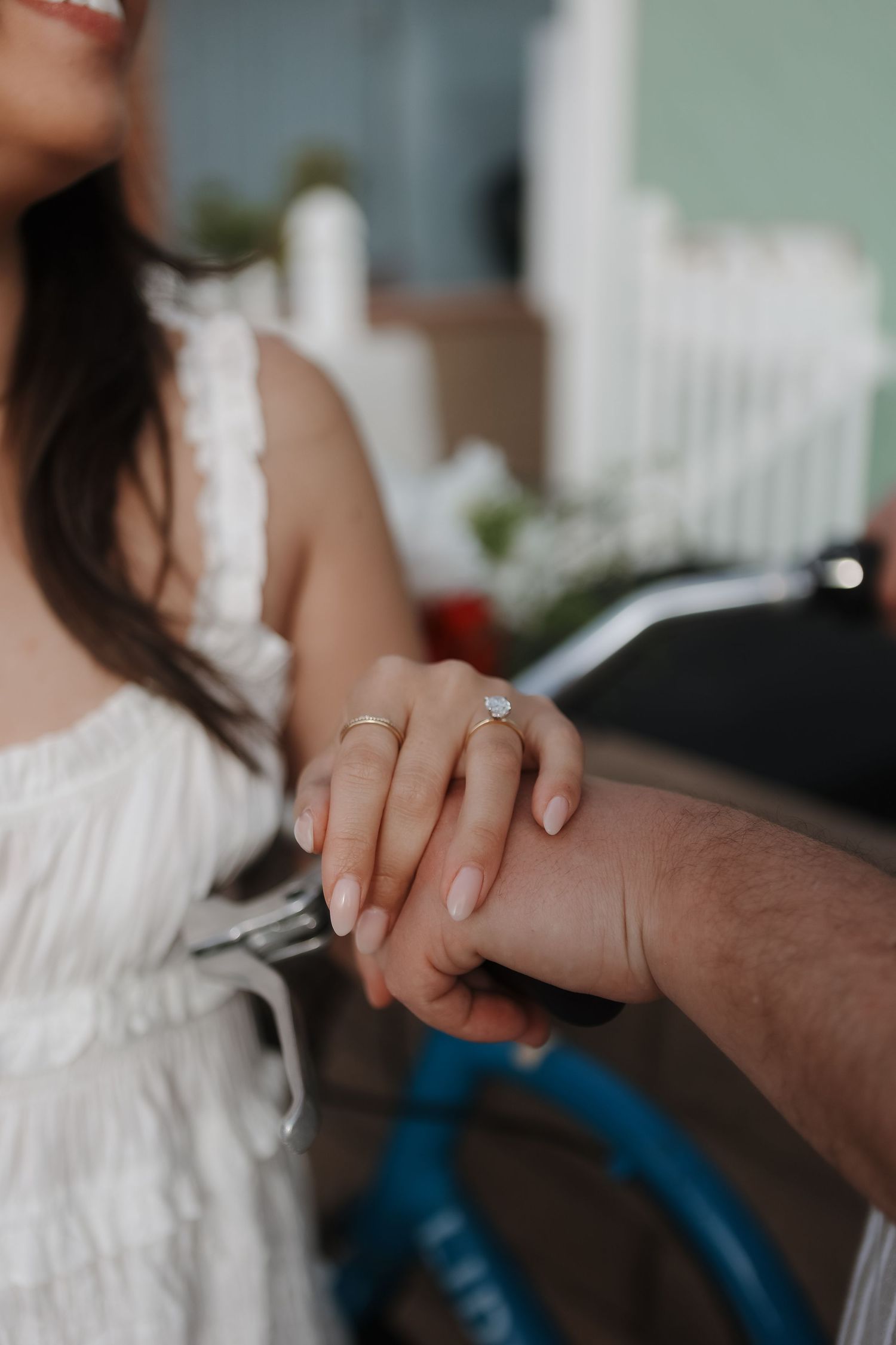 Close-up of hands showing an engagement ring in a romantic moment.