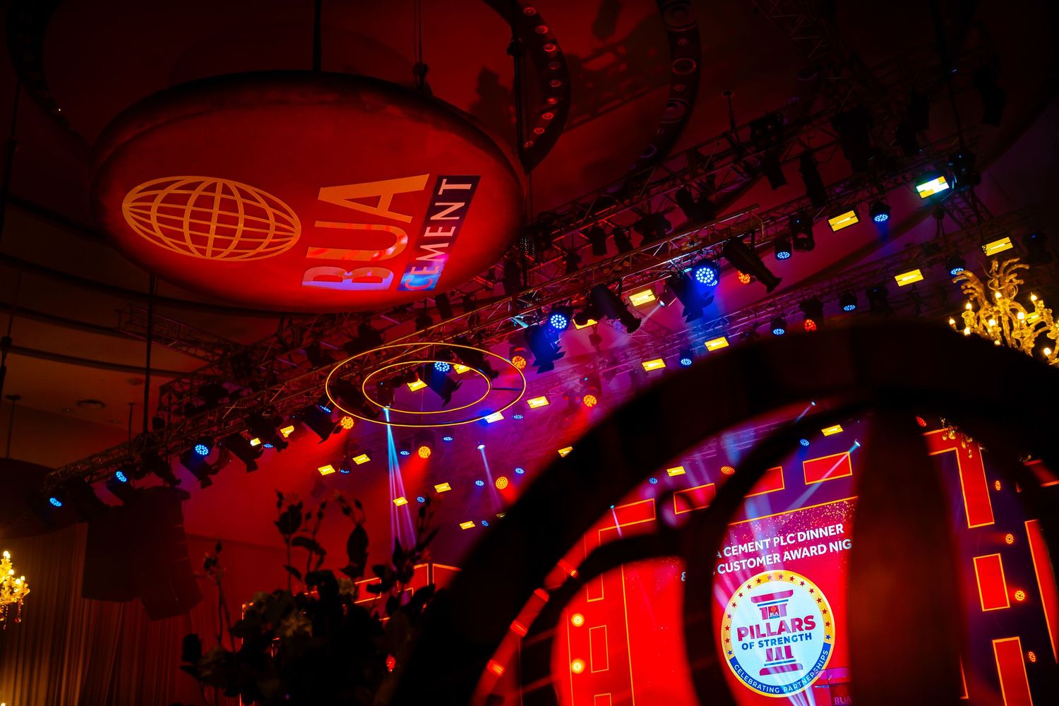 Concert venue illuminated with vibrant red and blue stage lights during a live performance.