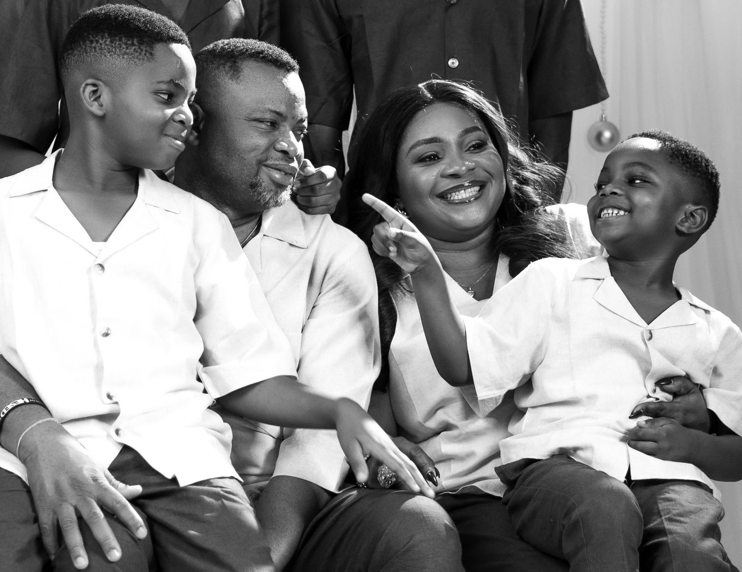 A series of black and white photographs showing joyful moments and laughter between people in casual settings.