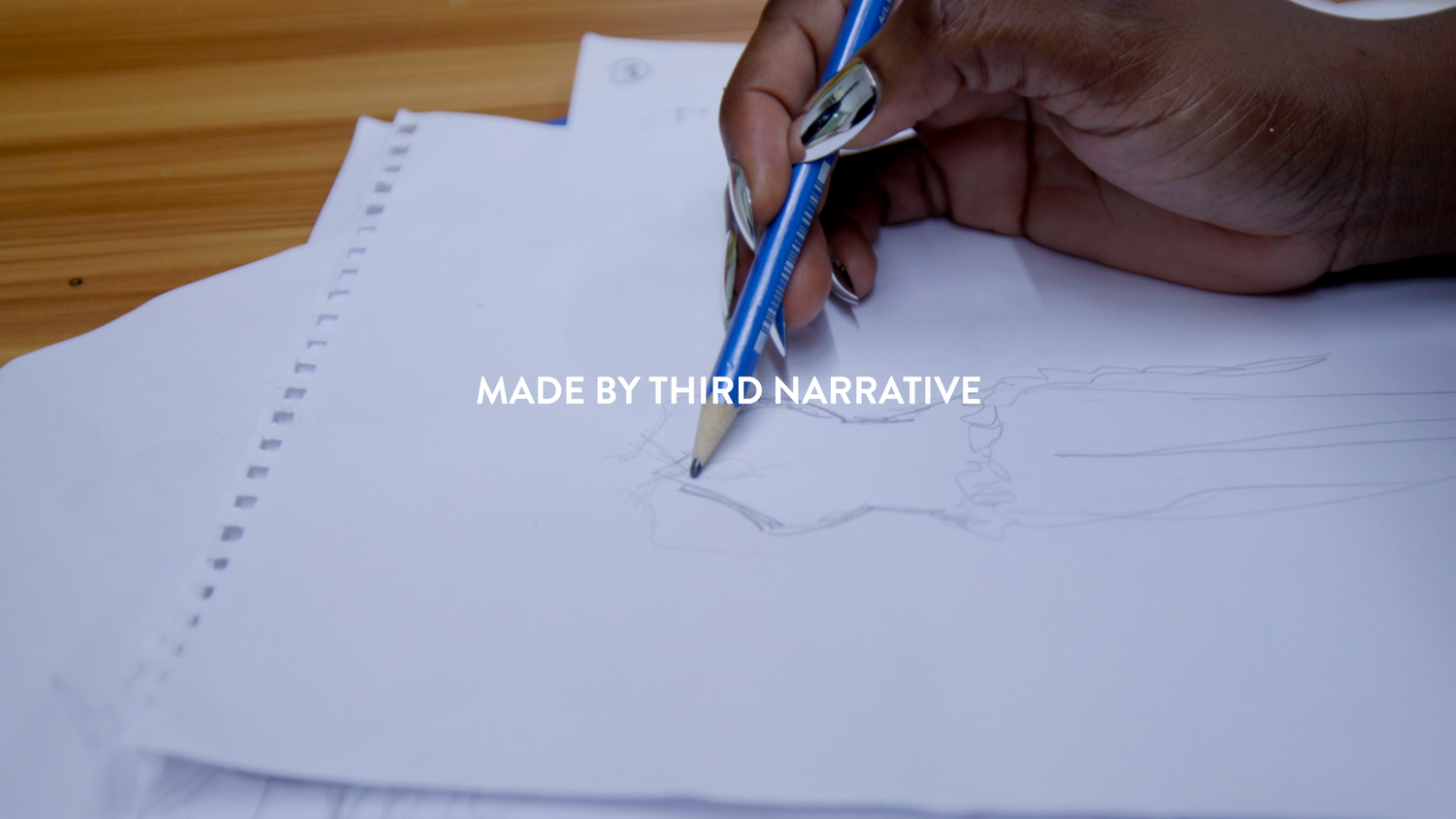 Close-up shot of hands writing on paper with text overlay reading 'Made by Third Narrative'.