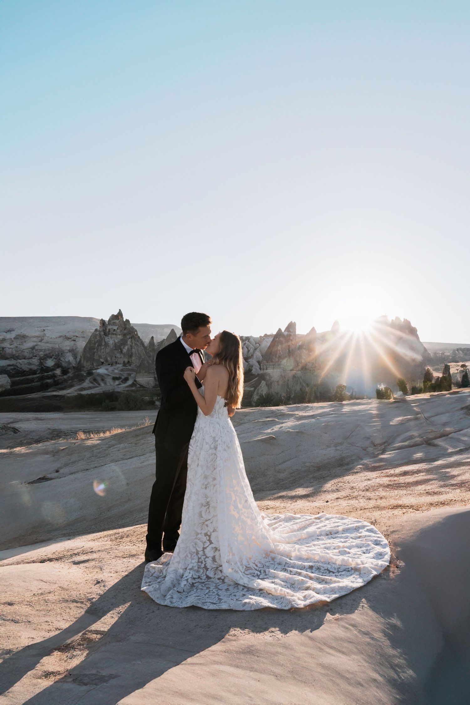 Wedding photographs at sunset in desert landscape with dramatic lighting.