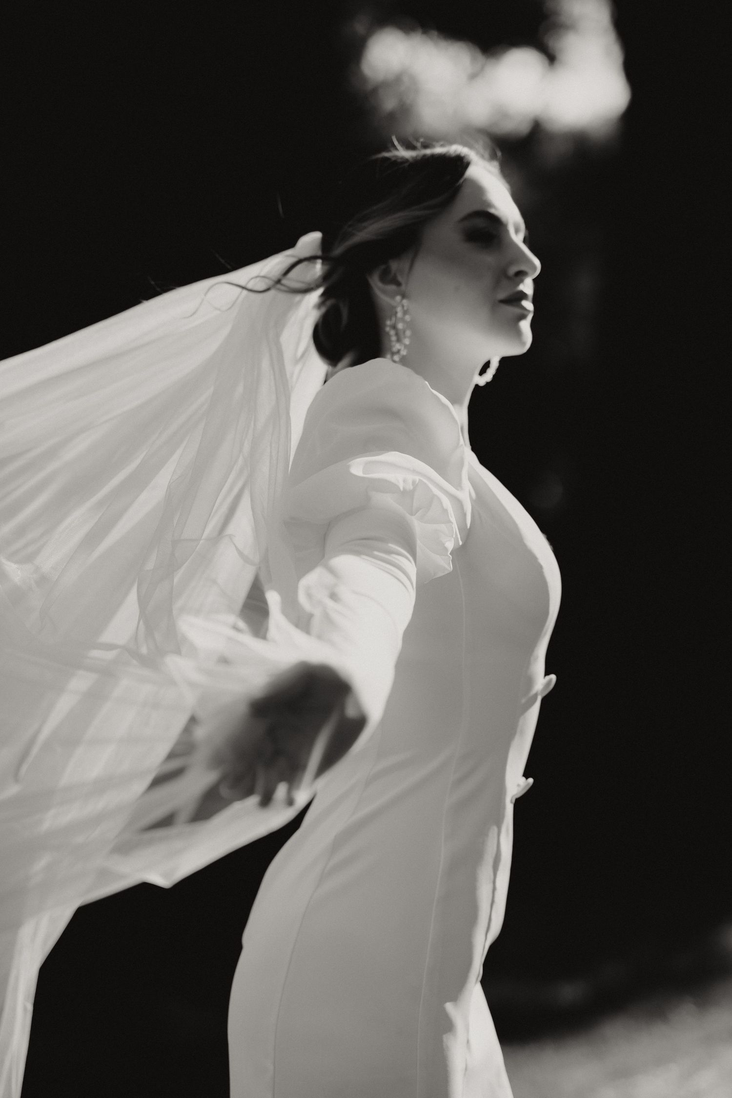 Artistic black and white sequence showing flowing white fabric against dark background creates ethereal movement.