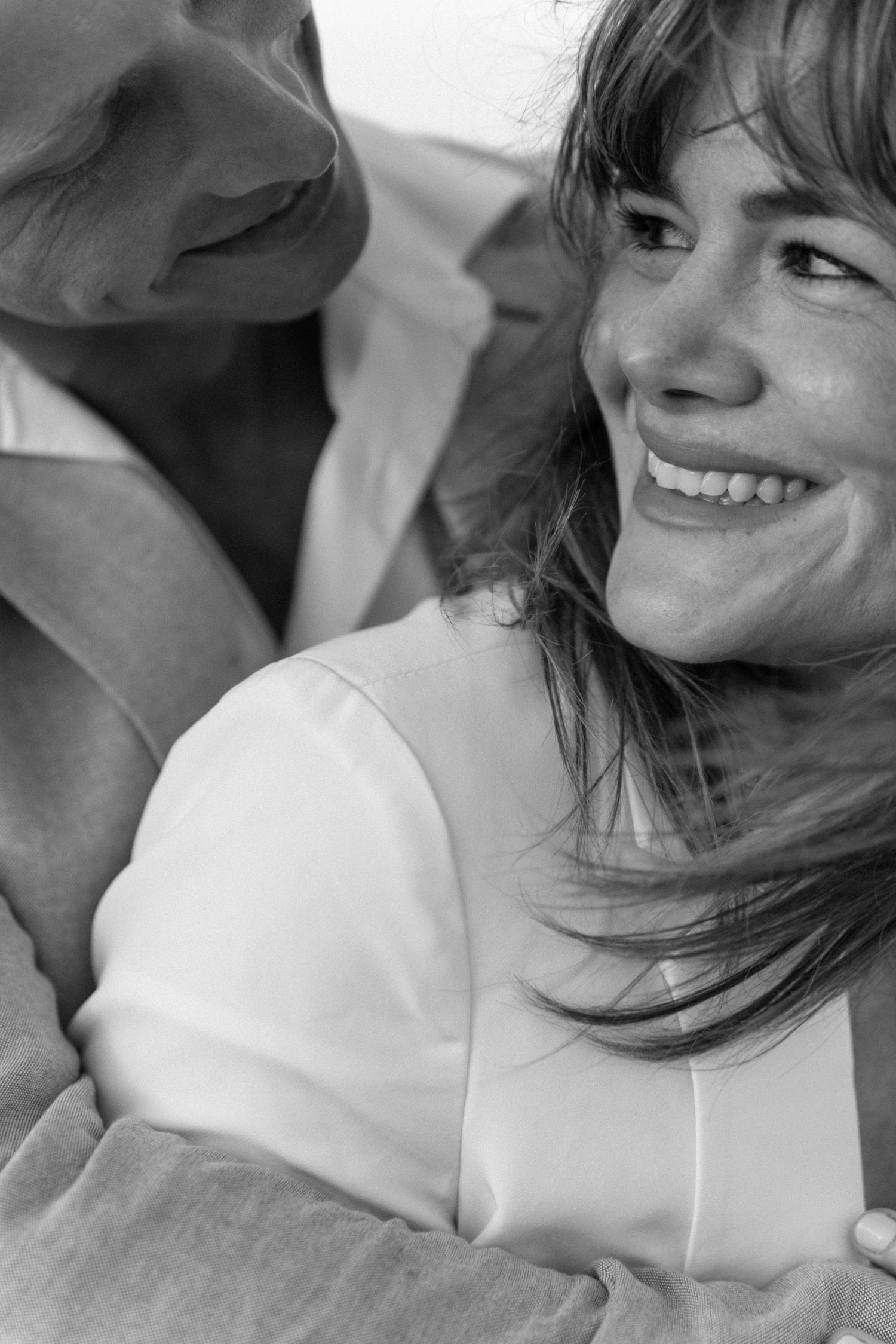 Close-up of tender moments between couple in white clothing.