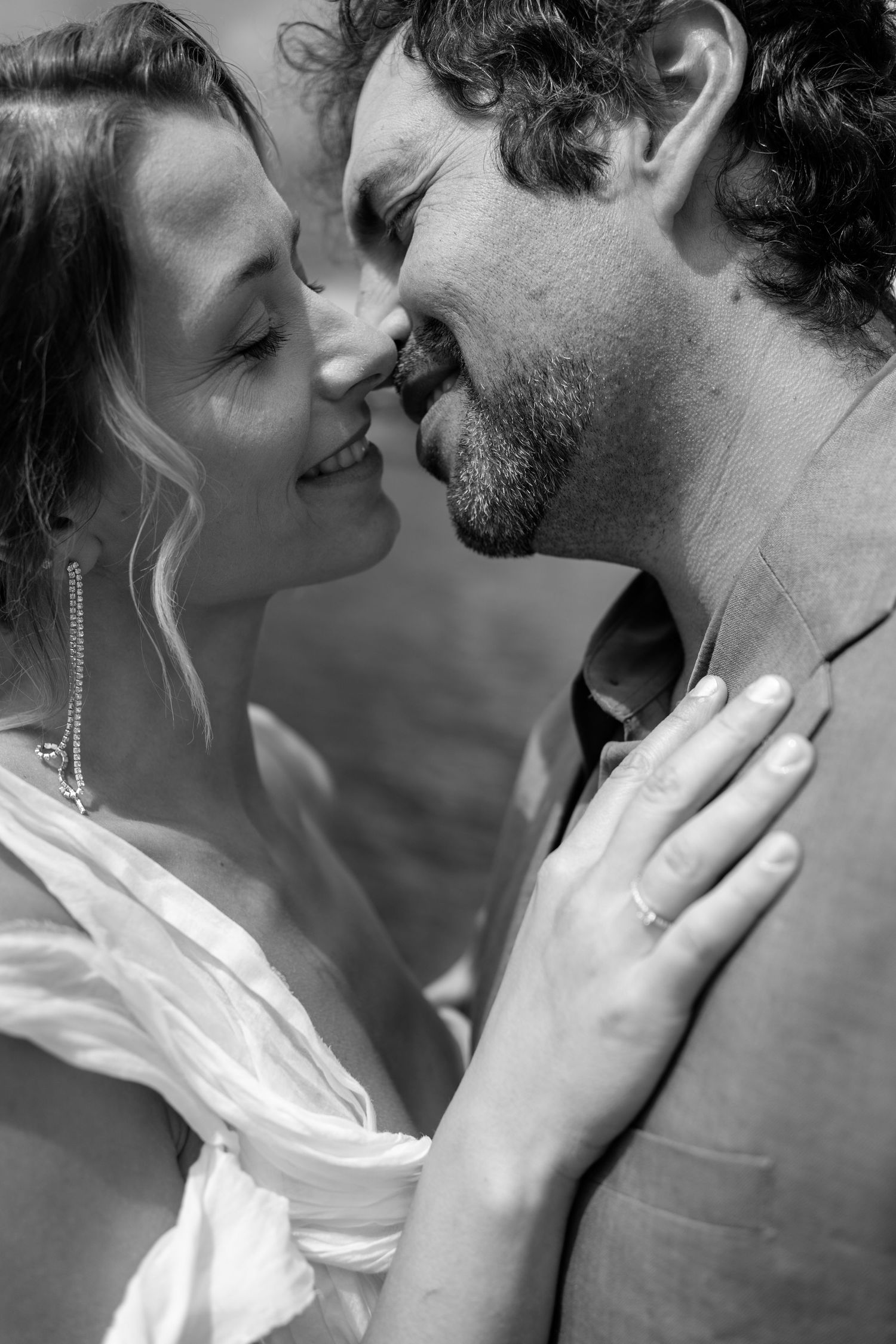 Intimate black and white close-up of a romantic moment between newlyweds.
