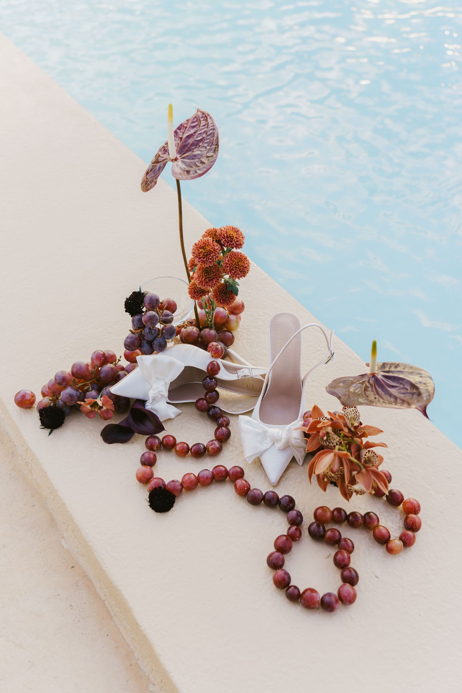 Decorative arrangement of dried flowers and hearts on a light surface.
