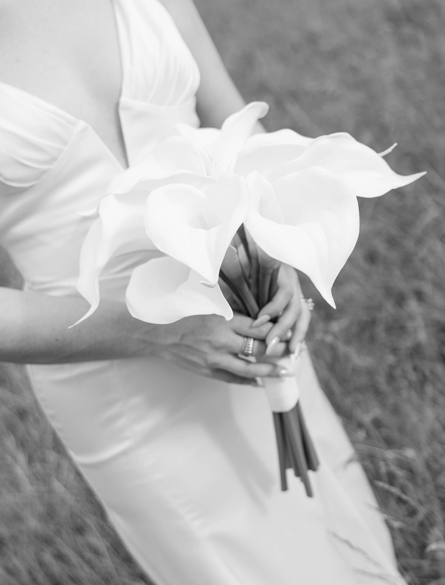 Close-up detail of flowing white wedding dress fabric in gentle motion.