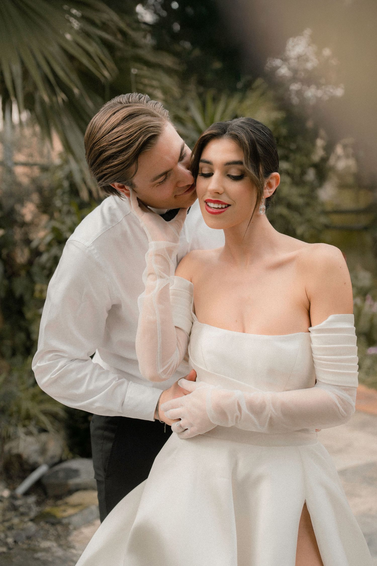 Romantic wedding portraits in white wedding attire with an ethereal natural backdrop.