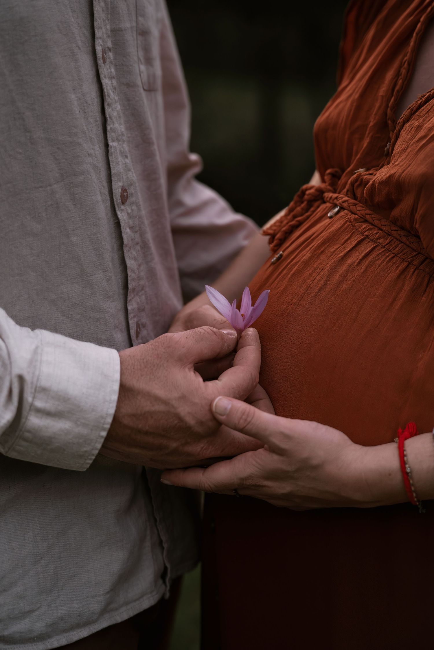Close-up sequences showing gentle hand touches and an exchanging of rings in natural lighting.