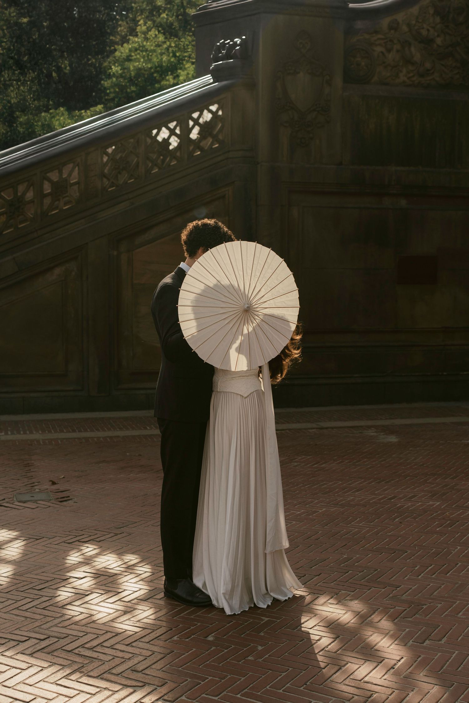 A dance sequence with parasol props captured in dramatic lighting.