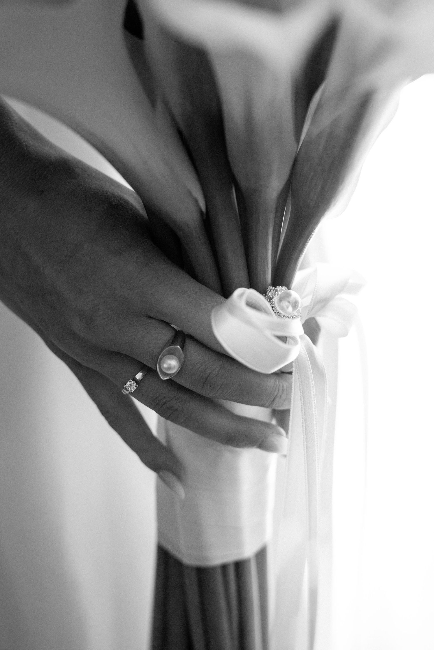 Close-up of hands adjusting formal dress details.