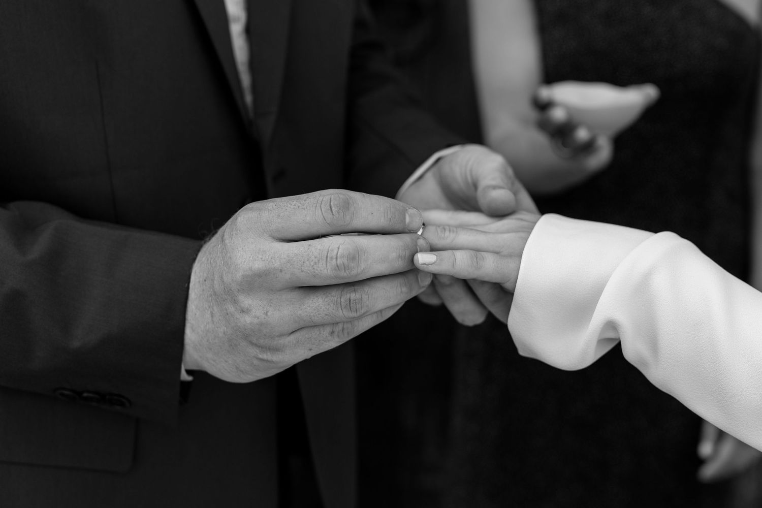 Close-up sequence showing the intricate details of a white wedding dress being buttoned up.