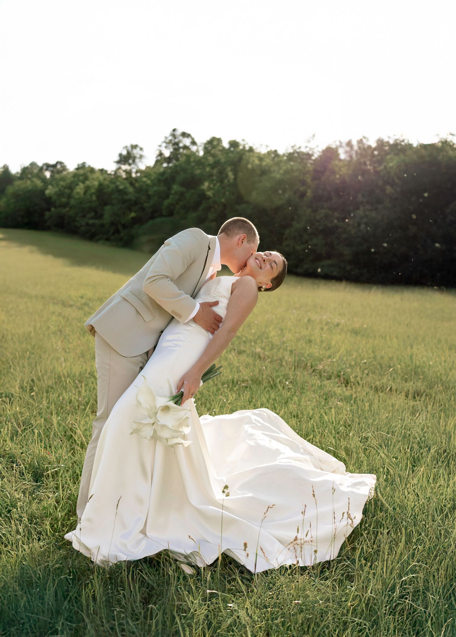 Artistic sequence of a bride in white dress posing in a sunlit meadow.