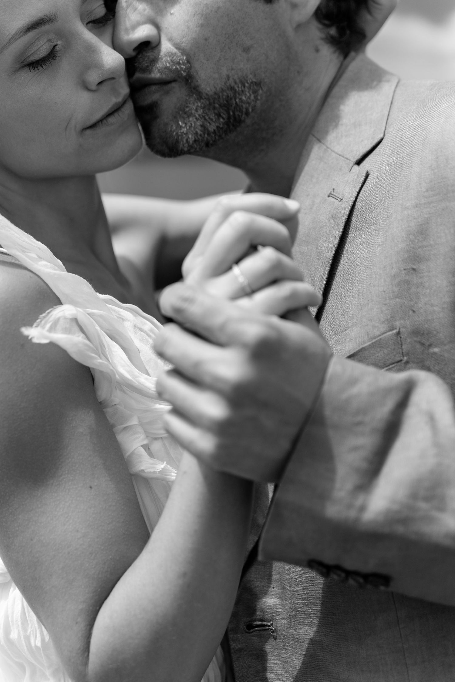 Romantic black and white close-up sequence of a couple sharing an intimate kiss.