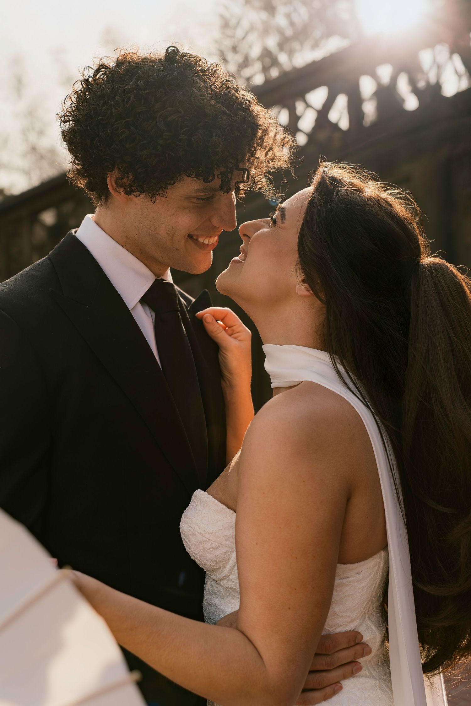 A romantic sunset moment captured between newlyweds during golden hour.