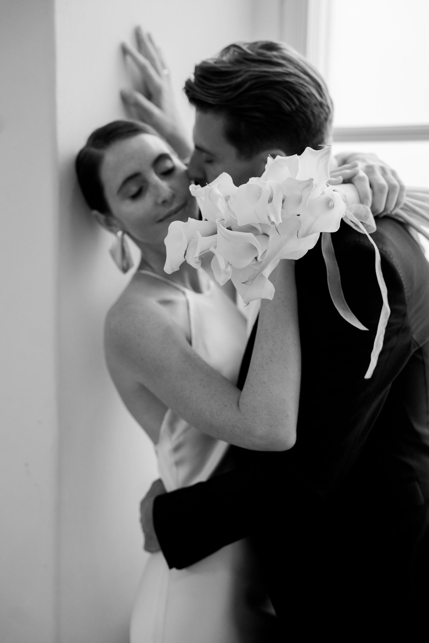 Black and white intimate dance sequence in natural window light.