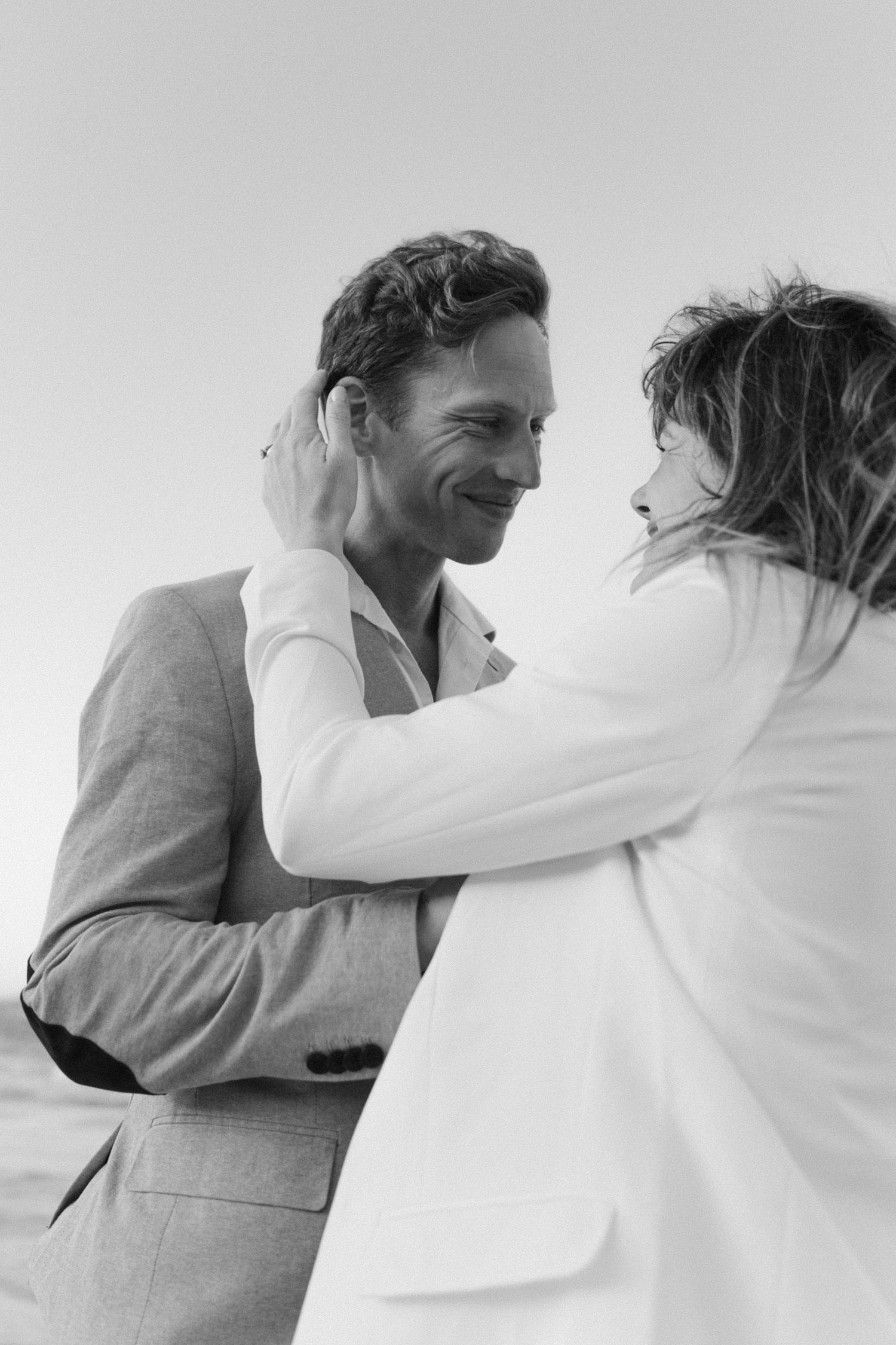 Romantic black and white photo sequence showing a tender embrace between a couple against a white background.