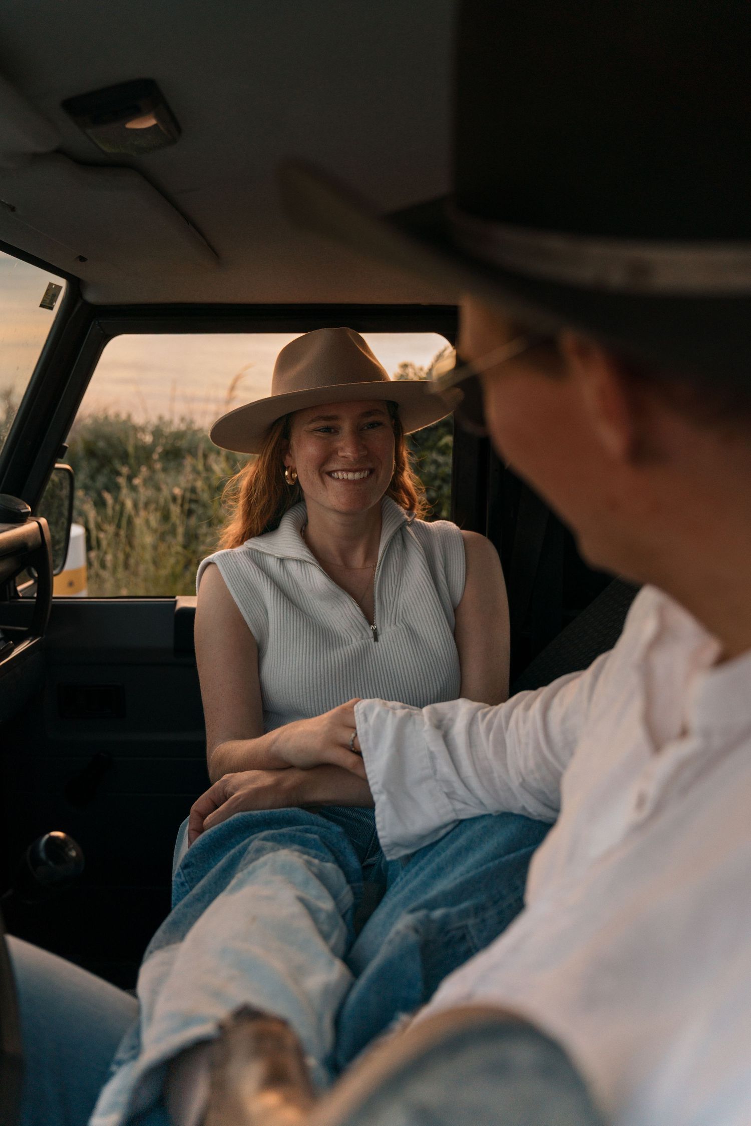 Candid moments of laughter and joy captured inside a vintage car.
