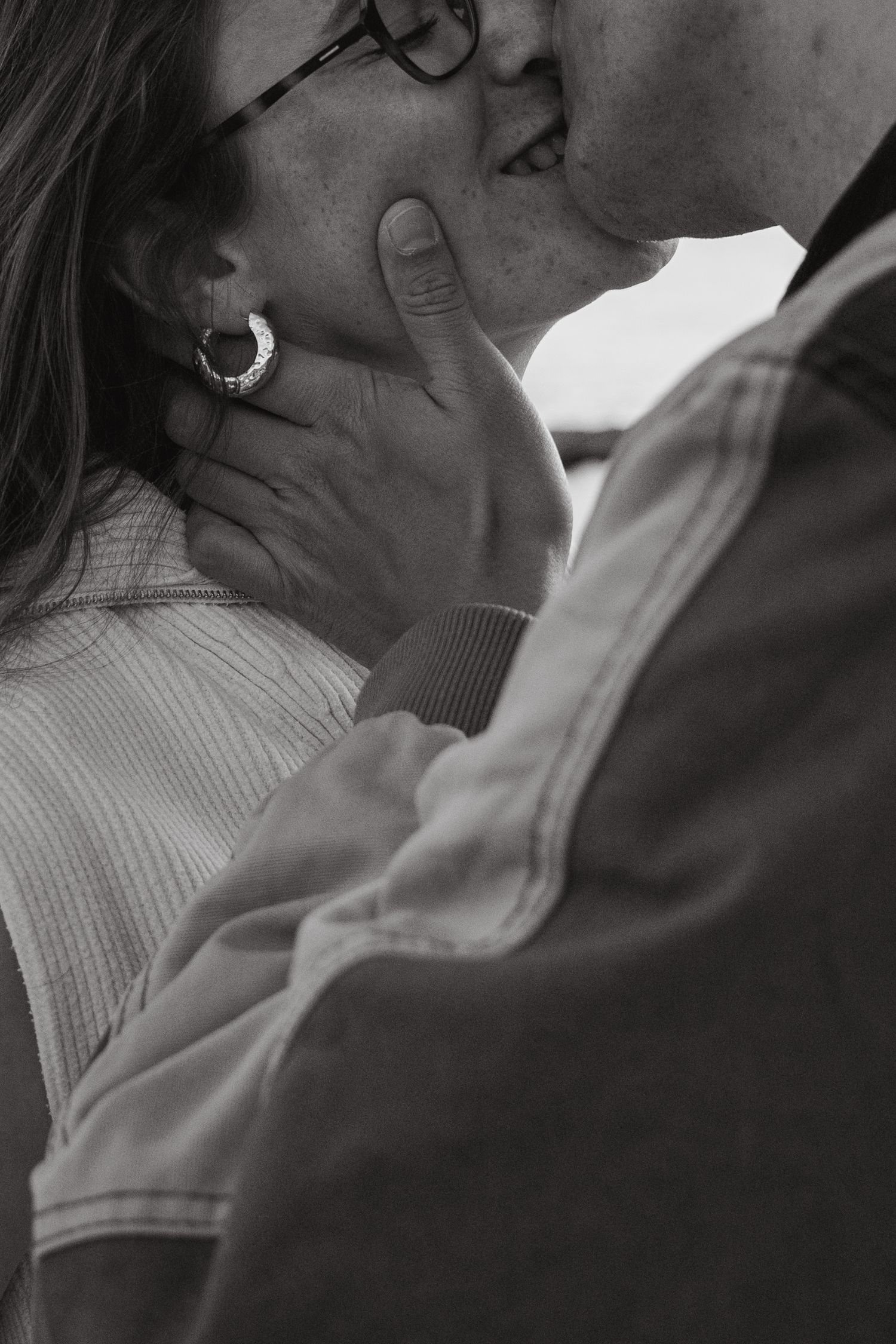 Black and white intimate portrait capturing tender moments between two people.